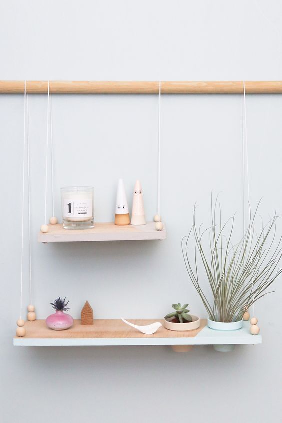 Minimalist hanging shelves   two color block ones with a pastel edge on a wooden holder