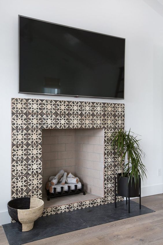 chic patterned earthy tone tiles and blush painted brick inside soften the living room decor and add chic