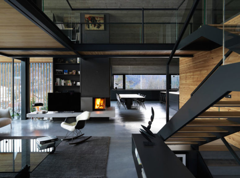 The spaces seamlessly flow into each other, a built-in fireplace brings coziness to all of them