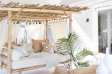06 a cabana-style outdoor daybed of wood with curtains and pillows will help you avoid any overheating here