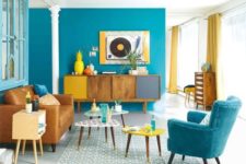 06 a colorful living room in bright blue, mustard and yellow brings the beauty of mid-century modern esthetics