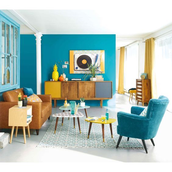 a colorful living room in bright blue, mustard and yellow brings the beauty of mid-century modern esthetics