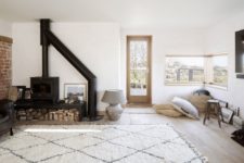 07 The living room is a welcoming space, with a hearth, pillows, views and much natural light