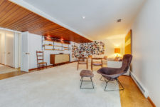 07 The third living area is done with lots of elegant mid-century modern furniture and a wall with decorative plates