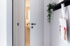 09 The entryway is sleek and simple, with a patterned floor and a large mirror