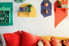 11 a colorful retro living room with a yellow and red sofa and bright touches on the wall – each shelf is different and highlighted with a different color