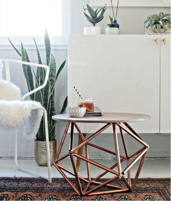 a stylish modern coffee table with a geometric copper base and a concrete countertop looks wow