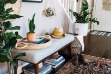 12 a boho summer entryway with potted plants and cacti, a boho rug, a wicker basket and an artwork