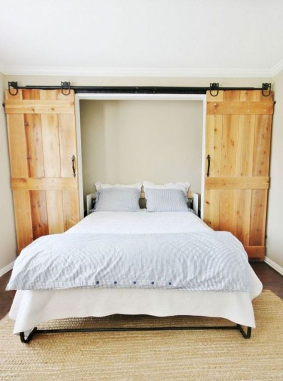 a cool Murphy bed hidden behind sliding barn doors is a great idea for a rustic space