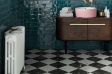 12 a retro bathroom with emerald tiles on the walls and black and white marble tiles on the floor