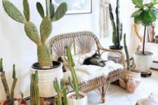 13 a bright boho summer entryway done with lots of cacti, a rattan bench with pillows and macrame