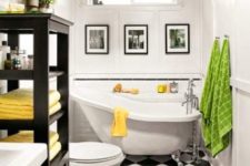 13 a monochromatic bathroom done with black and white tiles on the floor and spruced up with colorful towels and textiles