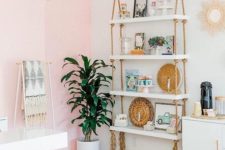 15 a hanging shelving unit with white shelves and simple ropes with long fringe add a boho feel to the glam space