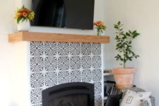 15 mosaic patterned grey and white tiles plus a wooden mantel look amazing and bring elegance to the rustic space
