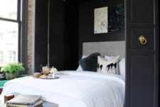 16 a stylishly hidden Murphy bed with black doors and ring pulls is a gorgeous idea for a refined bedroom