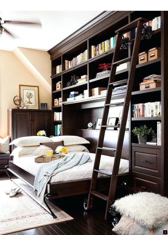 A traditional home office with a dark stained bookcase and a horizontally built in Murphy bed right in it