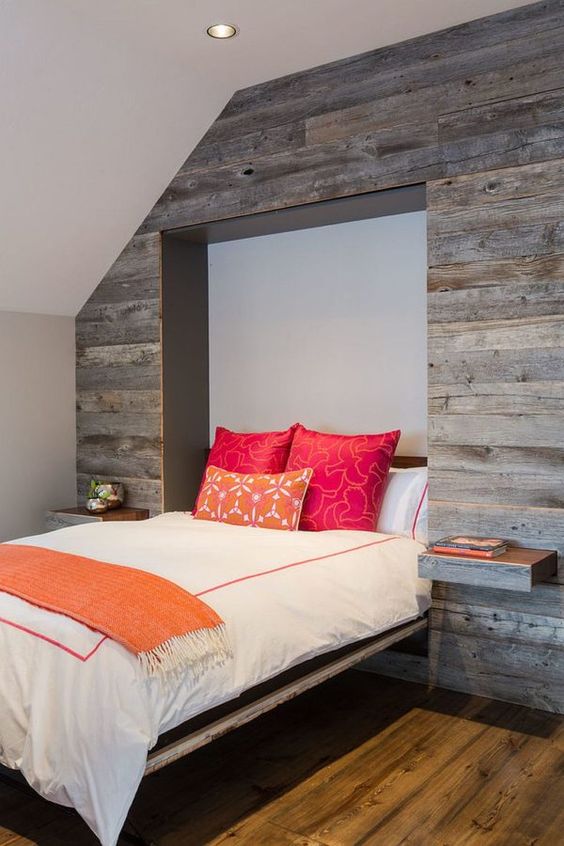 A Murphy bed and pull out nightstands disappear into the reclaimed wood wall when not needed