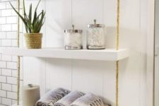 19 a simple and smart bathroom hanging shelf with thick white shelves and ropes can be easily DIYed