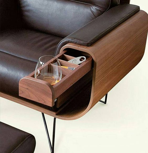 a small drawer hidden in the stylish leather upholstered sofa is a cool idea to save some space with style