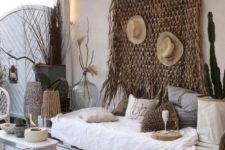 21 a whitewashed pallet daybed with lots of crochet pillows is the centerpiece of this desert-inspired boho outdoor space