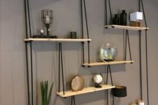 22 a whole hanging shelving unit with several shelves and black ropes looks very contrasting and will fit any boho room