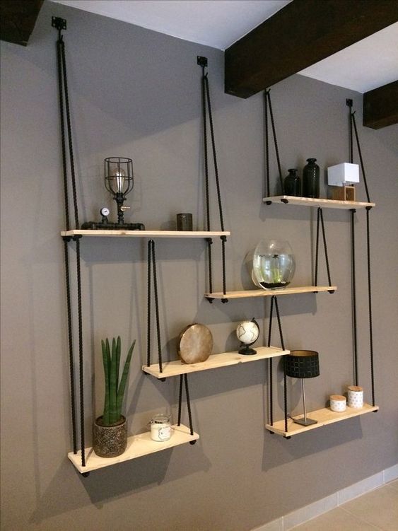 a whole hanging shelving unit with several shelves and black ropes looks very contrasting and will fit any boho room