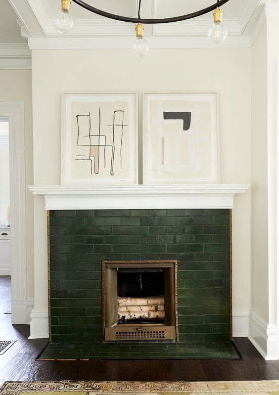 accent your small fireplace with dark green tiles and abstract artworks on the mantel if your home is mid-century modern or contemporary