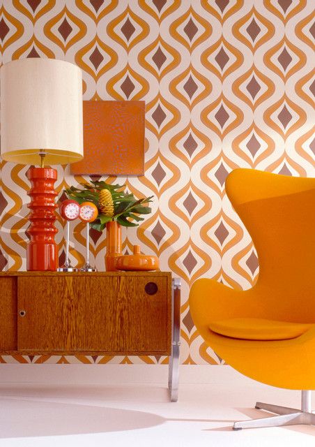 bright abstract wallpaper and a matching yellow egg-shaped chair for a chic retro nook