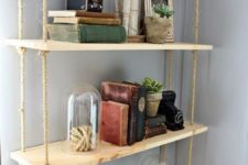 23 an industrial pipe with a hanging shelving unit with thin plywood tiers and ropes is a cool idea for an industrial space