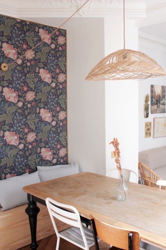 dark floral wallpaper on the accent wall instantly makes the dining space retro and stylish