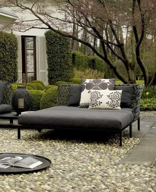 a contemporary dark daybed with printed pillows will accommodate more than one person and will add a modern feel to the space