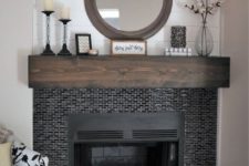 25 tiny glossy black tiles around the fireplace and a dark stained mantel make the fireplace zone cooler and bolder