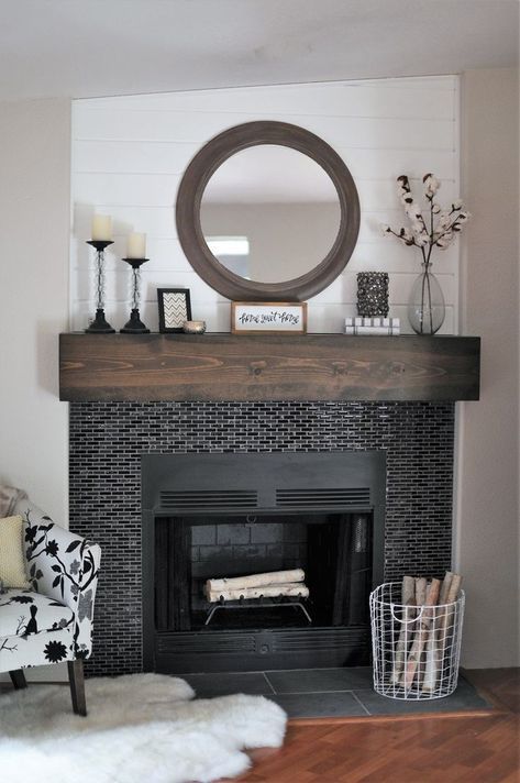 tiny glossy black tiles around the fireplace and a dark stained mantel make the fireplace zone cooler and bolder