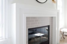 26 a clean and fresh idea of cladding your fireplace with thin light grey tiles and a white mantel covering the whole piece