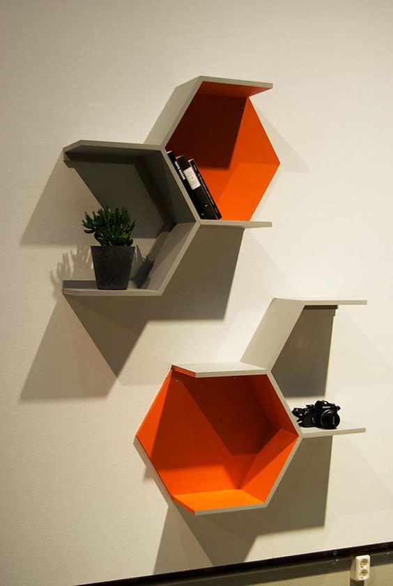 part hexagon shelves in grey and bold orange are a nice idea for storage and make a statement with the shape and color