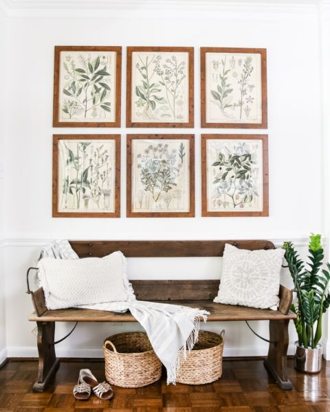 tropical leaves in a vase, baskets for storage and vintage botanical posters as artworks for a summer feel