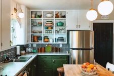 a 1950s farmhouse kitchen with white and green cabinets, a printed tile backsplash and a rug, a kitchen island with butcherblock countertops