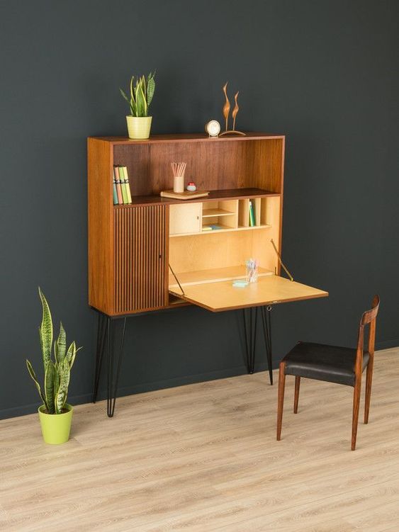 A Murphy desk integrated into a mid century modern storage unit with hairpin legs, the unit features much storage