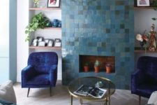 a bright living room with a faux fireplace clad with blue Zellige tiles and potted plants inside, which is a lovely statement
