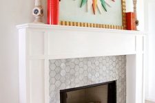 a built-in fireplace with marble hex tiles around it and on the floor and a stylish white frame and mantel