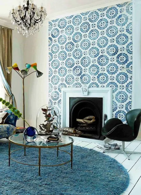 A built in vintage fireplace clad with blue and white patterned tiles that stand out and make the space more refined