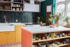 a colorful eclectic kitchen with emerald walls, a dark green chevron tile backsplash, bold cabinets and open shelves