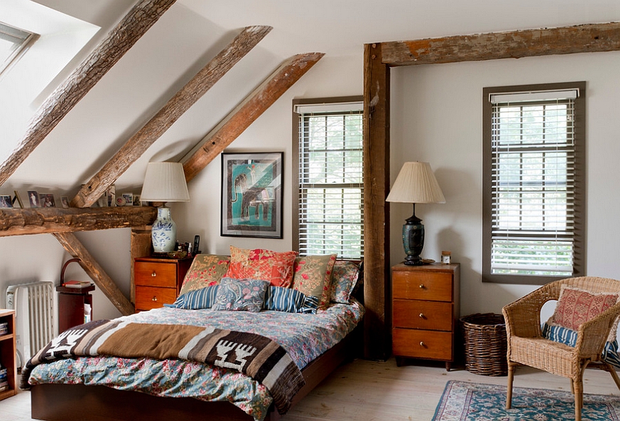 A comforting eclectic bedroom with mid century modern furniture, wooden beams, wicker chairs and elegant vintage lamps