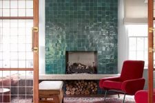 a faux fireplace with glazed green tiles around it and firewood storage under it for a chic look