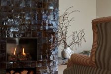 a fireplace clad with black Zellige tiles and a firewood niche is a stylish and eye-catchy idea due to its color and texture