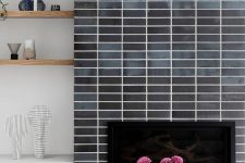 a fireplace clad with grey skinny tiles is a stylish idea for a mid-century modern living room, it looks nice