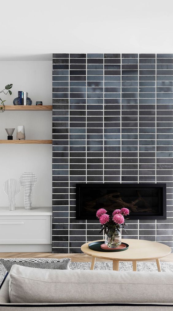A fireplace clad with grey skinny tiles is a stylish idea for a mid century modern living room, it looks nice