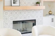 a fireplace clad with neutral printed tiles is a perfect fit for a living room, it looks very cohesive here