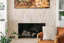 a fireplace clad with neutral skinny tiles is a stylish solution for a modern or mid-century modern space