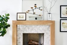 a fireplace clad with printed tiles, with a stained mantel and some decor on top is a lovely and chic idea for a living room